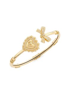 "Find DOLCE & GABBANA 18k Yellow & Diamond Sacred Heart Bangle on Editorialist. Signature yellow gold bracelet featuring the magnificent sacred heart, symbol of unconditional love and faith, and an elegant bow, both enriched with diamonds. The bracelet is adorned with beautiful baroque decoration, inspired by bourbon era. The DG logo is engraved inside the heart., Diamond, 0.25 tcw 18K yellow gold Made in Italy SIZE Diameter, 2.3\" ABOUT THE BRAND Mediterranean-inspired prints and luxe silhouettes are mainstays of the Italian label, launched in 1985 by Domenico Dolce and Stefano Gabbana. The eye-catching line includes a lineup of sleek clothing and maximalist shoes and handbags. Dolce & Gabbana. Color: Gold." Dolce And Gabbana Bracelet, Dolce And Gabbana Jewelry, Dolce Gabbana Jewelry, Love And Faith, Preppy Jewelry, Dg Logo, Designer Bracelet, Heart Symbol, Jewelry Accessories Ideas