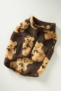 a brown and black dog print jacket on a white surface with the hood pulled up