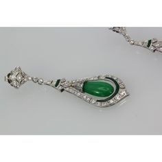 This is part of Chairish’s Fine Jewelry assortment.  Jade Enamel Diamond Long Earrings  These beautiful Jade Enamel Diamond long drop earrings consist of a teardrop Jade surrounded by Diamonds and green (same color as the Jade) Enamel. These earrings come from Spain and weight 16.2 grams. They are 5.3mm wide and 2 1/2" long. In beautiful condition. I love long drop earrings as I have long hair and when worn they show, but short haired women would like these as well because they make a bold state Elegant Green Polished Earrings, Elegant Green Earrings With Polished Finish, Luxury Green Teardrop Earrings, Elegant Green Long Drop Earrings, Exquisite Green Teardrop Earrings, Green Long Drop Earrings For Formal Occasions, Green Teardrop Jewelry For Evening, Elegant Green Pear-shaped Earrings, Elegant Green Teardrop Pendant Earrings