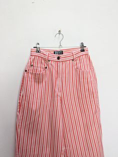 "a vintage pair of red and white stripe trousers ✿ IMPORTANT INFORMATION: * excellent vintage condition * material: 100% cotton * size: extra-small - please check exact measurements below (they're there for your benefit!) * garment care: machine washable ✿ MEASUREMENTS (taken while item is lying flat, some measurements will need to be doubled): * waist: 12\" (30cm) * hips: 18.5\" (47cm) * front seam: 11\" (28cm) * back seam: 15\" (38cm) * leg in-seam: 28.5\" (72cm) * leg out-seam: 40\" (102cm) * thigh: 11.5\" (29cm) * calf: 8\" (20cm) ✿ free UK shipping on orders over £100 with code STRAWBERRY free international shipping on orders over £250 with code LEMON ✿ please refer to measurements and shop policies before purchasing don't hesitate to get in contact if you have any further questions! Spring High-waisted Pants With Vertical Stripes, Striped Tapered Leg Bottoms For Spring, Spring Pants With Contrast Stripes, White High Waist Bottoms With Vertical Stripes, High-waist Summer Bottoms With Vertical Stripes, High Waist White Bottoms With Vertical Stripes, High Waist Pinstripe Cotton Bottoms, Summer Striped Tapered Leg Pants, Spring Bottoms With Contrast Stripes And Straight Leg