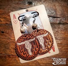 These beautiful handmade genuine tooled leather earrings feature hand painted western details and are hypoallergenic lead & nickle free! Tooled Leather Earrings, Newnan Ga, Tooled Leather, Leather Earrings, Leather Tooling, Jewelry Earrings Dangle, Etsy Earrings, Dangle Drop Earrings, Dangle Earrings