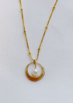 Classic and timeless in design and nature - the Whirl Necklace is a special piece made to make new memories in. 14 K gold-filled White Freshwater Pearl Recycled Gold Box Chain Jewelry As A Gift, Recycled Gold Box Chain Jewelry For Gift, Recycled Gold Box Chain Jewelry Gift, Gift Jewelry In Recycled Gold With Box Chain, Anniversary Gold Pearl Necklace In Sterling Silver, Classic Gold Nickel-free Necklace, Nickel Free Yellow Gold Necklace For Everyday, Recycled Gold Box Chain Necklace With Round Pendant, Elegant 14k Gold Filled Nickel-free Necklaces