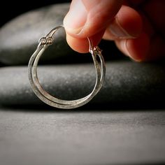 Sterling silver hammered hoop earrings 1"   A pair of earrings to go with everything!  These are so light and easy to wear, hammered for texture and hinged so they are easy to put on.  They are made of sterling silver by me in my studio and textured with an old beat up hammer my husband bought me about 10 years ago.  The texture is wonderful, you won't see it anywhere else.  They are a little over 1" in diameter. I can make these bigger or smaller or out of gold.  Please convo me with any special requests. I make other really great hoop earrings and you can see them here: http://www.etsy.com/shop/hartleystudio/search?search_query=hoop+earrings&search_submit=&search_type=user_shop_ttt_id_5388170&shopname=hartleystudio&langid_override=-1 All purchases come lovingly boxed and ready for giving Silver Hammered Small Hoop Jewelry, Hammered Sterling Silver Hoop Earrings In Silver, Silver Hammered Sterling Silver Hoop Earrings, Silver Hammered Hoop Earrings For Everyday, Everyday Sterling Silver Hammered Hoop Earrings, Simple Hammered Silver Jewelry, Everyday Silver Hammered Hoop Earrings, Hammered Adjustable Small Hoop Earrings, Small Hammered Adjustable Hoop Earrings