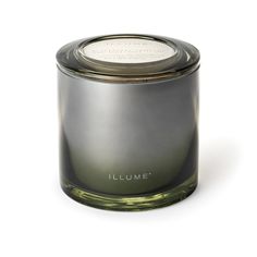 a candle that is sitting on a white surface with the words illumet written in it