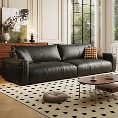 a modern living room with black leather furniture