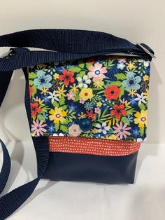 "This fully lined purse is a one-of-a-kind creation suitable for young children as well as the young at heart due to it's small but practical size and fully adjustable strap. Perfect for a trip to the mall or world travelling. A full back pocket just right for a bus pass, keys, cell phone or a passport.  Magnetic closure 60\" adjustable shoulder strap.  Purse size is roughly 5.5\" x 6.5\" x 1\" or 14 cm x 16.5 cm x 2.5 cm." Multicolor Floral Embroidered Shoulder Bag For Travel, Kids Purse Flower, Printed Fabric Bags, Unique Crossbody Bag, Casual Multicolor Flower-shaped Shoulder Bag, Casual Multicolor Flower-shaped Bag, Floral Print Cotton Flower-shaped Bags, Bus Pass, Vintage Crossbody Bag