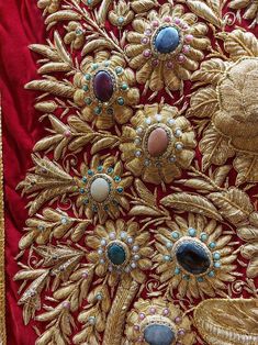 an elaborately designed red cloth with gold trimmings and jewels on the edges