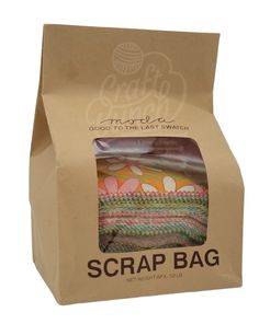 a brown paper bag with an orange and green striped design on the inside of it