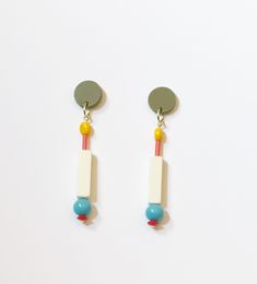 These cool classics are right at the intersection where minimal meets FUN. The acrylic green posts lend a strong foundation to the yellow, coral, off white, aqua and red beads that dangle down. They're lightweight, comfortable and easy to wear--but still make a statement!  Length: 3" At Supercute, we try super hard to use sustainable, recycled, and/or upcycled materials. We source vintage beads from estate sales, garage sales, our local craft swap, our own collection -- and even Etsy! Each piece is designed, hand assembled, packaged and sent to you from our studio in Arlington Heights, Illinois.  Our jewelry makes for wonderful and unique gifts. If you'd like a free gift wrap, please leave that in a comment and we'll gift wrap the box before shipping! Minimalist Multicolor Dangle Earrings, Minimalist Yellow Earrings For Pierced Ears, Modern Yellow Earrings For Everyday, Modern Yellow Earrings For Everyday Wear, Minimalist Yellow Pierced Earrings, Modern Multicolor Earrings For Everyday, Multicolor Earrings, Earrings Colorful, Red Beads