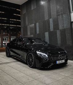 a black car parked in front of a building