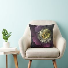 a chair with a pillow on it next to a potted plant