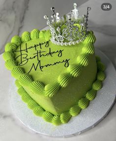 a green heart shaped cake with a crown on top