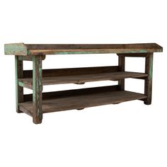 an old wooden shelf with two shelves underneath it