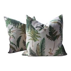 two pillows with green leaves on them