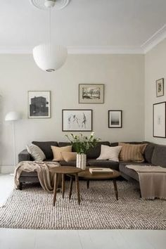 a living room filled with furniture and pictures on the wall above it's coffee table