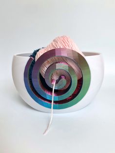 a white bowl with yarn in it