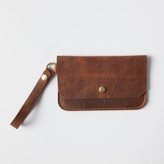 + DIMENSIONS Height: 5.25 inches Width: 8.5 inches Wristlet strap length: 5.5 inches + WRISTLET CLUTCH DETAILS Keep your friends close – and your daily essentials closer. When you need a sleek way to carry the basic necessities, you can't go wrong with KMM & Co.'s leather wristlet clutch. Handmade in the same full-grain leathers as your favorite tote, the wristlet has space for your cards, keys, and phone. Each wristlet clutch features an undivided main compartment, plus a rear pocket that you c Basic Necessities, Tan Leather Tote, Best Tote Bags, Leather Tote Bags, Leather Handbags Tote, Wristlet Clutch, Leather Clutch Bags, Leather Bucket Bag, Leather Bags Handmade