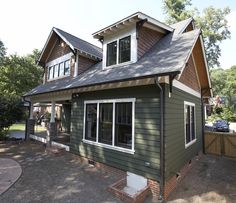 a green house with white trim and windows