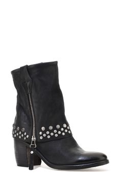 Double-down on contemporary Western styling in this leather boot designed with a dual zip closures and a fold-over-look shaft dotted with studs around the arch-grazing cuff. 3 1/2" heel; 1/2" platform 7 1/4" shaft Dual side-zip closures Leather upper and lining/synthetic sole Imported Rugged Moto Boots With Rivets For Fall, Biker Boots With Rivets For Fall, Punk Leather Moto Boots With Silver Studs, Winter Leather Boots With Silver Studs, Leather Moto Boots With Studs For Winter, Winter Leather Moto Boots With Studs, Leather Moto Boots With Spikes For Winter, Fall Rivet Boots For Biker Events, Punk Leather Boots With Silver Studs