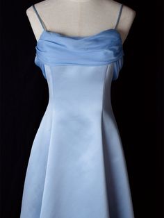 Step into timeless elegance with this Vintage Blue Satin Gown. Crafted from luxurious satin, this dress features delicate spaghetti straps that provide a graceful and feminine silhouette. The highlight of this gown is its unique winged back design, adding a touch of whimsy and sophistication. Perfect for formal occasions, evening events, or any special celebration, this elegant dress ensures you'll make a stunning entrance. The vintage blue hue adds a classic touch, making it a versatile additio Elegant Spaghetti Strap Evening Dress For Debutante Ball, Elegant Evening Dress With Spaghetti Straps For Debutante Ball, Satin Wedding Dress With Spaghetti Straps And Fitted Bodice, Evening Dress With Satin Finish, Fitted Bodice, Spaghetti Straps, Elegant Blue Evening Dress With Spaghetti Straps, Blue Satin Evening Dress With Ruched Bodice, Blue Satin Evening Dress With Spaghetti Straps, Blue Spaghetti Strap Dress For Debutante Ball, Satin Finish Evening Dress With Spaghetti Straps