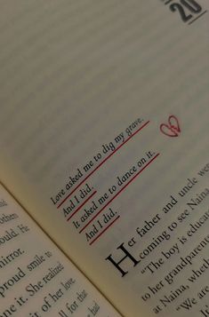 an open book with some writing on the pages and red marker in it's center