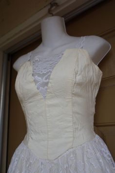 "Stepping Out 1980s party dress. Small - see measurements., Boned bodice. Zips and ties in the back. Overall good vintage condition but could use pressing - off white from age. Made by Stepping Out Measurements taken across front lying flat 16\" across front armpit to armpit 13\" across front of waist 37\" length armpit to bottom" Fitted Lace Trim Corset Dress For Prom, Sweetheart Neckline Corset Dress With Lace Trim For Prom, Wedding Corset Dress With Lace Bodice And Spaghetti Straps, Fitted Lace Bodice, Formal Corset Dress With Lace Trim And Fitted Bodice, Cream Party Dress With Corset Back, Vintage Overbust Dresses With Lace Trim, Summer Lace Corset With Lined Bodice, Sleeveless Lace Trim Corset Wedding Dress