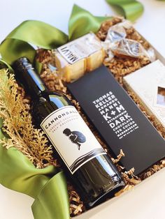 a bottle of wine and some chocolates in a box