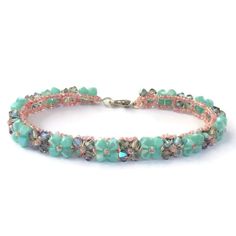 A Handmade Bracelet Woven Mint Green Glass Crystals With A Pearlescent Shine And Gray Green Glass Crystals With A Green Rainbow Iridescent Finish. Accented With Pretty Pink Seed Beads. Made With Extra Strong Beading Thread For Durability. Measures Approximately 7.5 Inches, But Can Be Made Any Length At Your Request. Not Intended For Children Under 12. Pretty Seed Bead Bracelets, Pink Bracelets For Spring Parties, Spring Party Pink Bracelets, Spring Turquoise Bracelet Jewelry, Spring Turquoise Jewelry Bracelet, Spring Beaded Bracelet For Parties, Elegant Pink Beaded Bracelets For Summer, Handmade Pastel Jewelry For Spring, Handmade Turquoise Beaded Bracelets For Spring