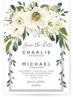 a wedding card with white flowers and greenery