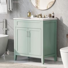 a white bath tub sitting next to a bathroom sink under a round mirror on a wall