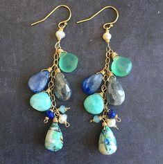 These Oyster Arizona Lapis Turquoise ( bottom stones) are like beautiful little landscape paintings. Every pair will be unique. Shown are two recent examples of earrings that have already shipped out. These are a one of a kind earrings due to the uniqueness of the turquoise. The pair shown has sold. The other stones are freshwater pearls, chalcedony, amazonite, silvered labradorite, kyanite and lapis lazuli. As shown these are on the 14k gold filled French ball earwires. Please choose your metal Chrysoprase Gemstone Drop Earrings, Turquoise Dangle Earrings With Ocean-inspired Style, Turquoise Dangle Earrings Ocean-inspired, Artisan Turquoise Earrings With Natural Stones, Ocean-inspired Turquoise Dangle Jewelry, Artisan Turquoise Gemstone Earrings, Handmade Turquoise Chrysoprase Earrings, Nature-inspired Turquoise Dangle Earrings, Turquoise Nature-inspired Drop Earrings