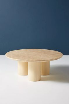 a round wooden table with three legs