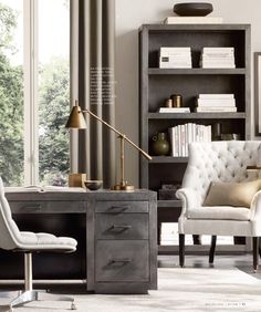 a living room filled with furniture and a book shelf next to a window covered in curtains