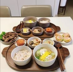 there are many bowls on the table with chopsticks and food in them to eat