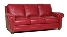 a red leather couch sitting on top of a white floor