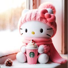 a hello kitty doll holding a cupcake and wearing a pink hat with a pom - pom on it