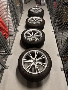 four tires are lined up on the floor