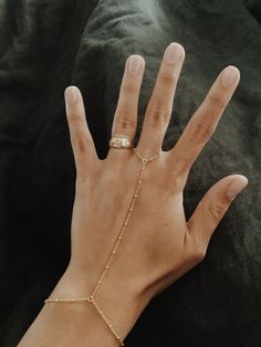 "This is a beautiful beaded hang chain in 14/20 gold-fill. Perfect for when you want something a little more special on your hand. It's great for laying and can be worn and never taken off. 14/20 Gold-fill reacts the same as 14k gold, in that it will never turn silver and if it gets dirty, a little cleaning will bring it back to its original shine! Measurements: The bracelet part of the piece is a little more than 7\", the chain up is 3.5\" and the chain around the finger is 2.5\". But if you ne Chain Ring Bracelet, Finger Bracelets, Ring Bracelet Chain, Gold And Silver Bracelets, Jewelry Bracelets Gold, Couple Jewelry, Hand Chain, Gold Bracelet Chain, Bracelet Charm