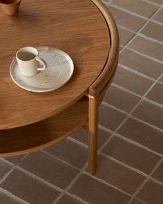 a coffee table with two cups on it and a saucer next to the cup