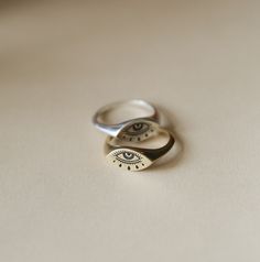 Our Evil Eye ring is cast in sterling silver, brass, or 14k gold and is a sweet nod to our love of art that is rooted in an age-old tradition. The "evil eye" dates back to ancient civilizations and has been adopted by many cultures as a symbol of good luck and protection. Aside from its symbolism, the eyes are the most powerful and important part of the human body. It's what shapes our reality and what inspires us to create in the first place. Materials & Details Your choice of Silver, Brass or Evil Eye Ring Silver, Evil Eye Ring, Ring Ideas, Local Jewelry, Eye Ring, The Human Body, Ancient Civilizations, Rings Simple, Everyday Jewelry