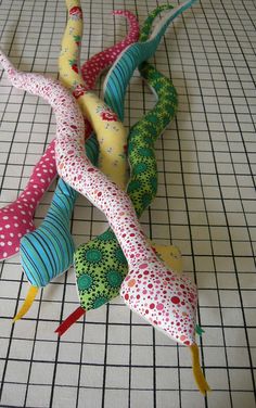 several different colored umbrellas laying on a tiled floor next to each other with polka dots