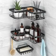 two black shelves with soap, lotion and other bathroom items on them in the corner of a white tiled wall