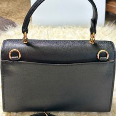 This Beautiful And Rare Coach Tilly Top Handle Satchel Bag Comes In Classy Black Color. It's Crafted From Rich Top Quality Textured Crossgrain Leather And Features A Middle Compartment With Zippered Closure, Gold Tone Signature Hardware, And A Signature Hand Tag. Superior Quality Craftsmanship With A Sleek Silhouette, Attractive Stitching And Many Other Details Gives This Bag A Unique And Classy Look. Top Handle And Long Crossbody/Shoulder Strap Offer Versatile And Comfortable .Nwot High-end Black Flap Bag With Gold-tone Hardware, High-end Black Flap Bag, High-end Black Formal Bags, High-end Black Satchel Flap Bag, High-end Black Bags With Detachable Strap, High-end Black Crossbody Shoulder Bag, Black High-end Satchel Flap Bag, High-end Black Flap Bag With Removable Pouch, Business Clutch Bag With Branded Hardware