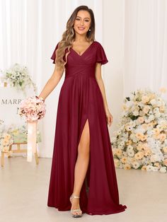 the bridesmaid wears a deep red gown with short sleeves and thigh high slit