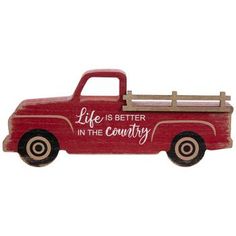 a red truck with the words life is better in the country