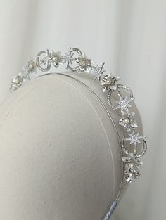 The New Romantics Collection The New Romantics Petite Halo Headband is handcrafted using an array silver and white tone flower shapes to give a modern bridal feel, finished with fresh water pearls among crystal moons and stars for that perfect celestial look. The halo is lightweight and easy to wear. If you have difficulty with headbands please do let me know as they can be stretched out for your comfort. The New Romantics Collection features this petite halo, as well as a set of hairpins. Perfect for matching your headpiece with your bridesmaids and flower girls (please note this listing is for the petite halo only). The petite halo range are designed to wear simply on their own or paired up with another of our headbands for that extra look. For example the Romantic's halo would look grea Hair Stars, Moon Headband, Gold Bridal Crown, Headband Bride, Gold Bridal Crowns, Bridal Flower Headband, Bridal Halo, Bridal Fascinator, Cape Wedding Dress