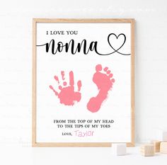 a framed print with the words i love you momma and handprints on it