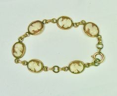 Hand carved vintage shell cameo bracelet is gold filled with a spring ring clasp.  Each oval shape cameo is approximately 1/2 inch high and 3/8 inch wide and each carved face is slightly different.  The bracelet is made up of six cameos and is seven inches in length. Estate Style Oval Gold Jewelry, Vintage Cameo Bracelet Jewelry, Antique Oval Cameo Bracelet, Antique Oval Gold Bracelet, Antique Oval Hallmarked Bracelet, Vintage Cameo Bracelet, Vintage Intaglio Bracelets For Formal Occasions, Antique Cameo Bracelet For Wedding, Antique Oval Link Bracelet For Formal Occasions