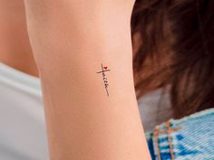 a woman with a small tattoo on her arm