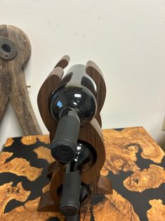 a bottle of wine sitting on top of a wooden table